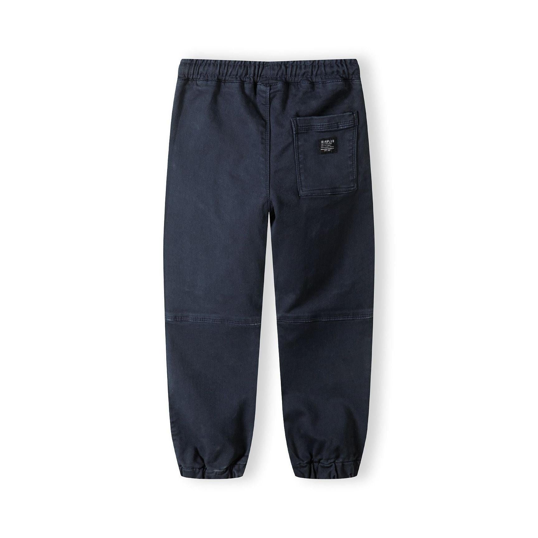 Back view of navy knitted cargo trousers displaying single back pocket with logo patch, elastic waistband, and relaxed fit styling on white background