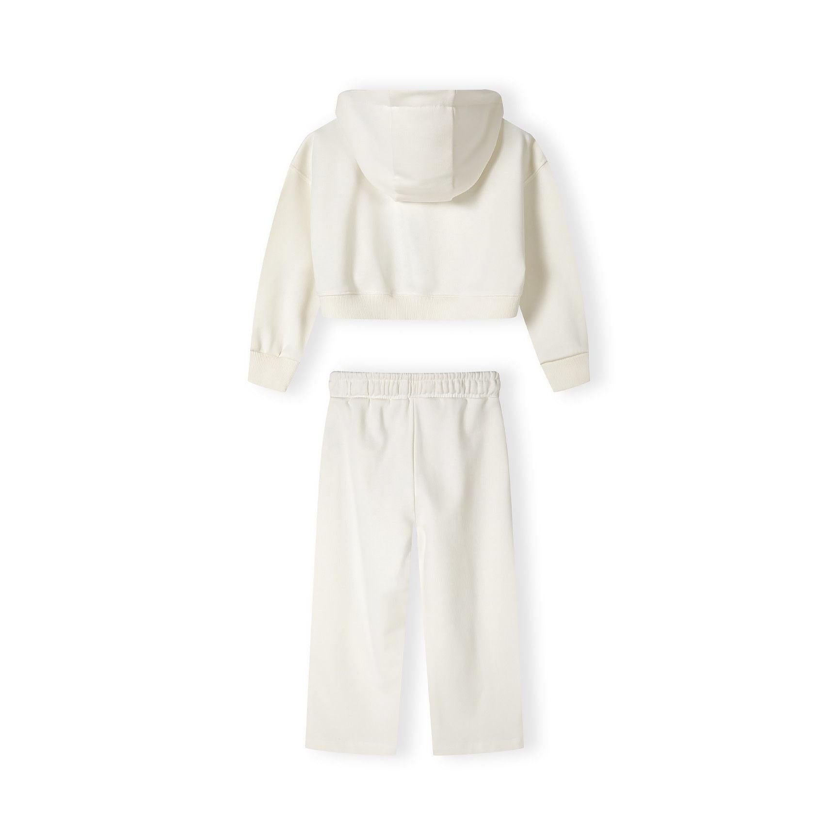 Close-up detail of cream joggers showing blue vintage-style text print reading 'USA 1967' with memories script text