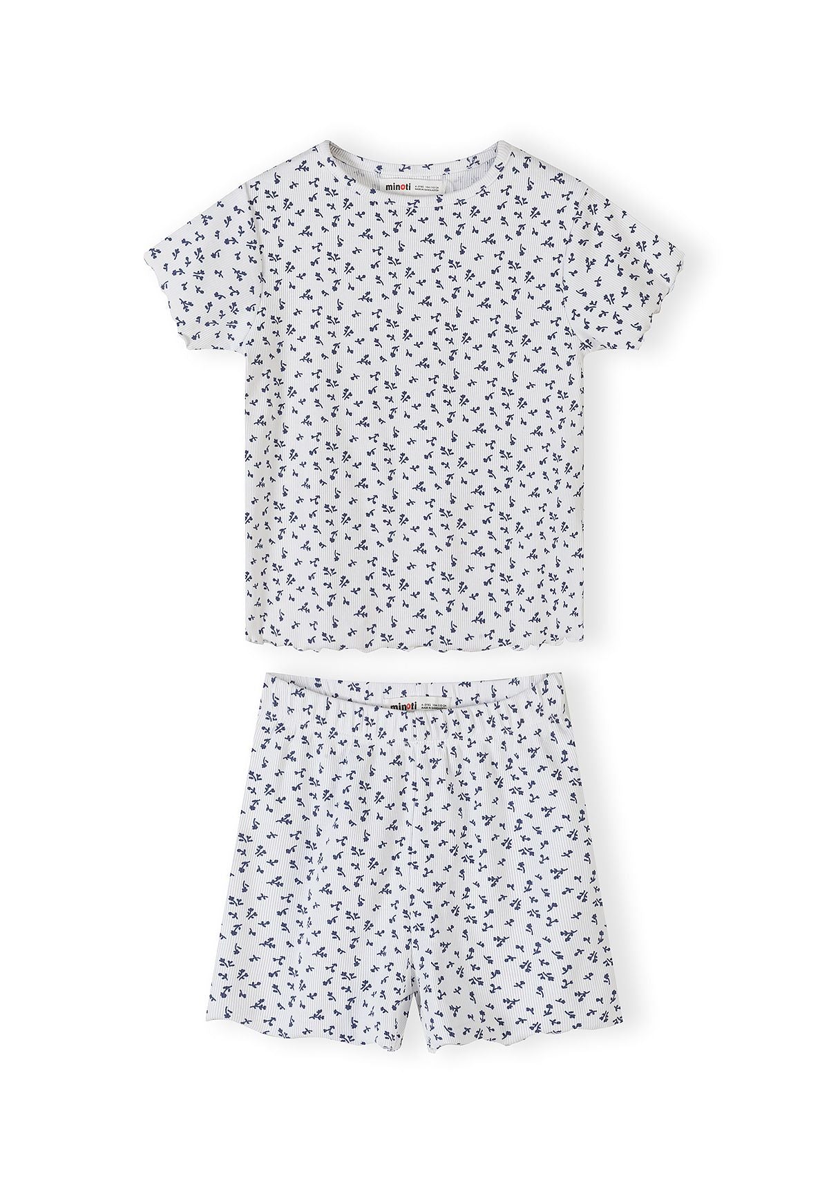 Navy pyjama set with white floral print showing short sleeve top and matching shorts with scalloped edges on white background
