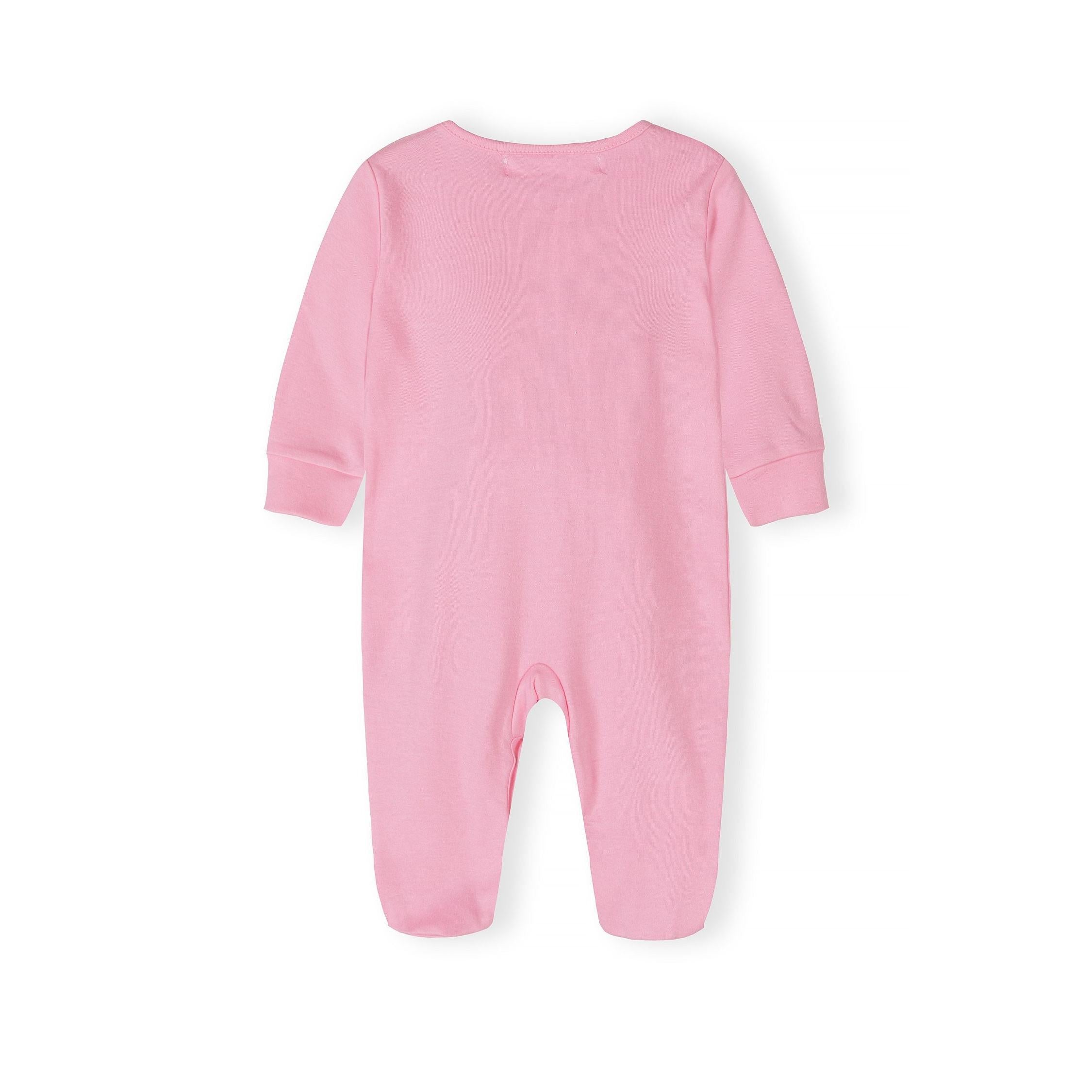 Close-up detail of cream sleepsuit showing Minoti label, snap button closures and ribbed neckline construction