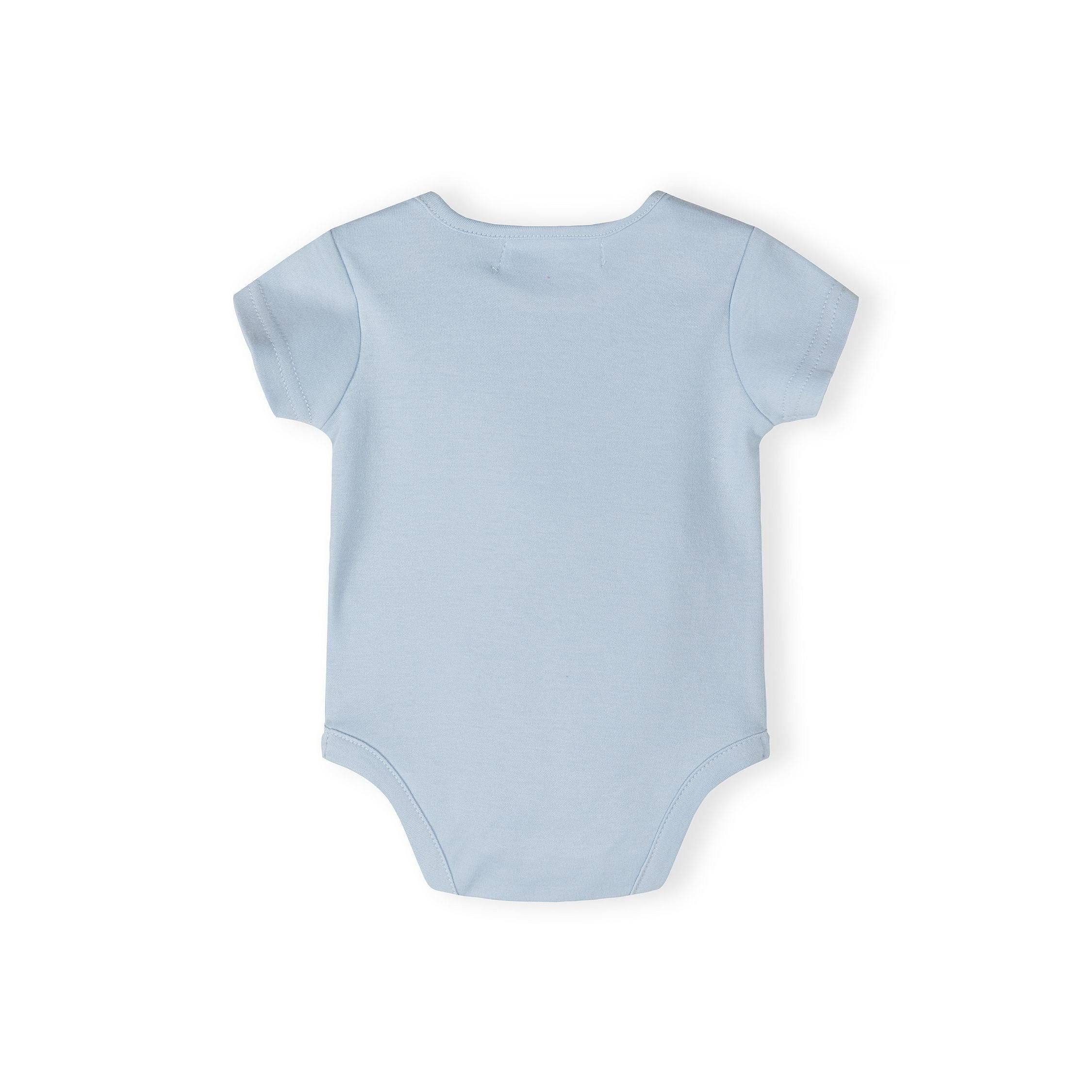 Close-up detail of cream bodysuit showing blue dinosaur with red spikes, speech bubbles saying 'AWESOME' and 'COOL', and Minoti size label