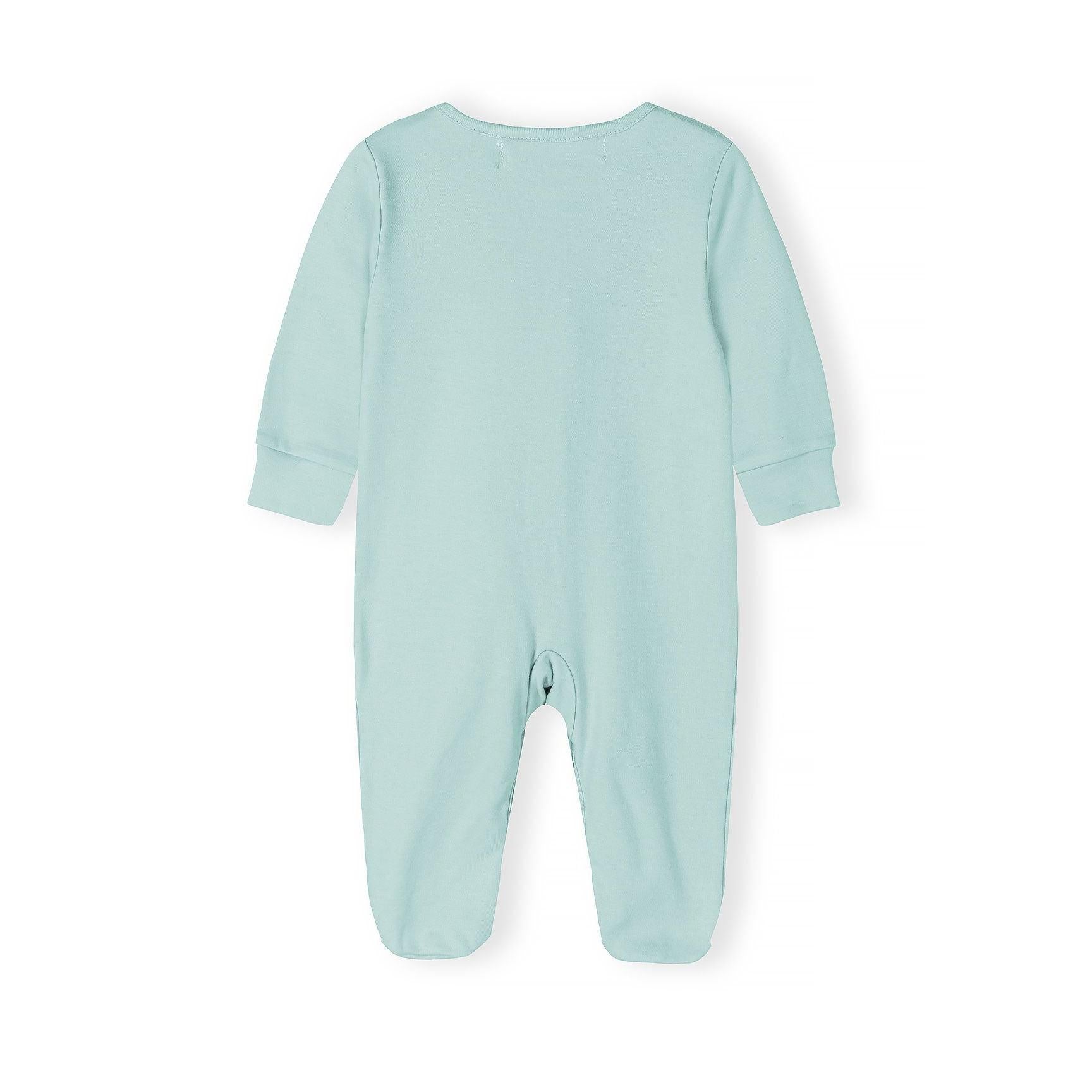 Close-up detail of mint green sleepsuit showing snap button fastenings and Minoti brand label at the neckline with soft jersey fabric texture visible