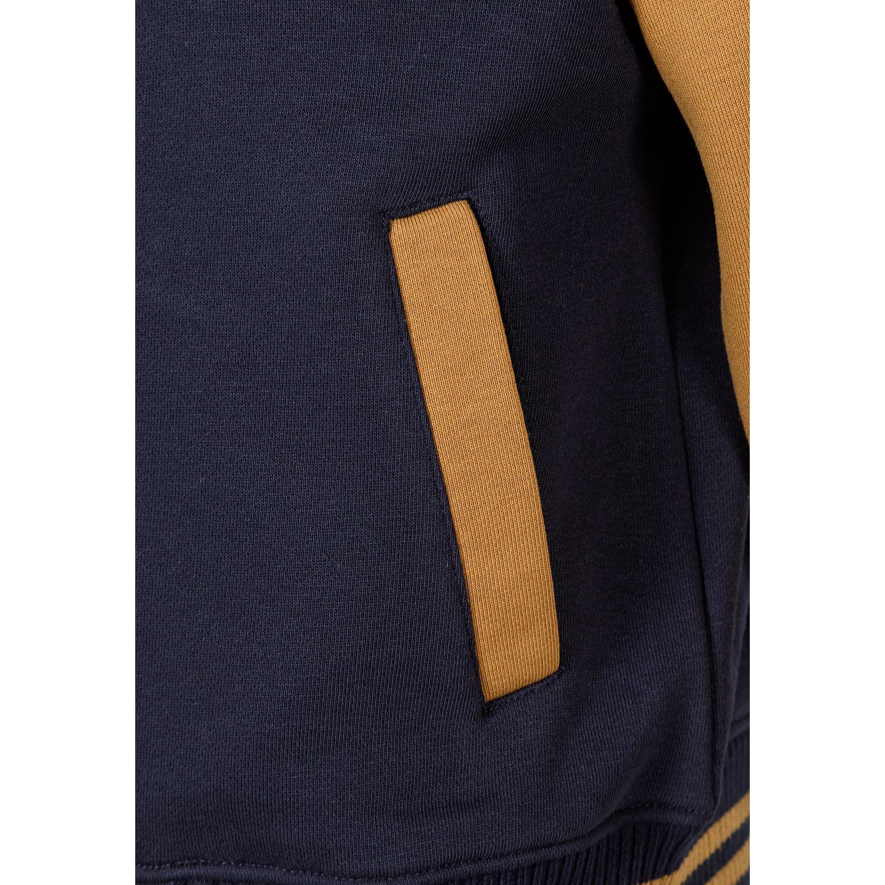 Close-up detail of navy fabric showing side pocket with toffee contrast trim