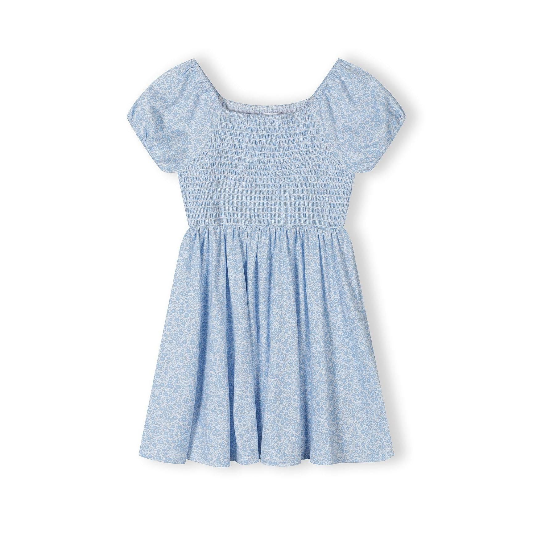 Light blue floral dress laid flat showing smocked bodice detail, short sleeves and flowing skirt on white background