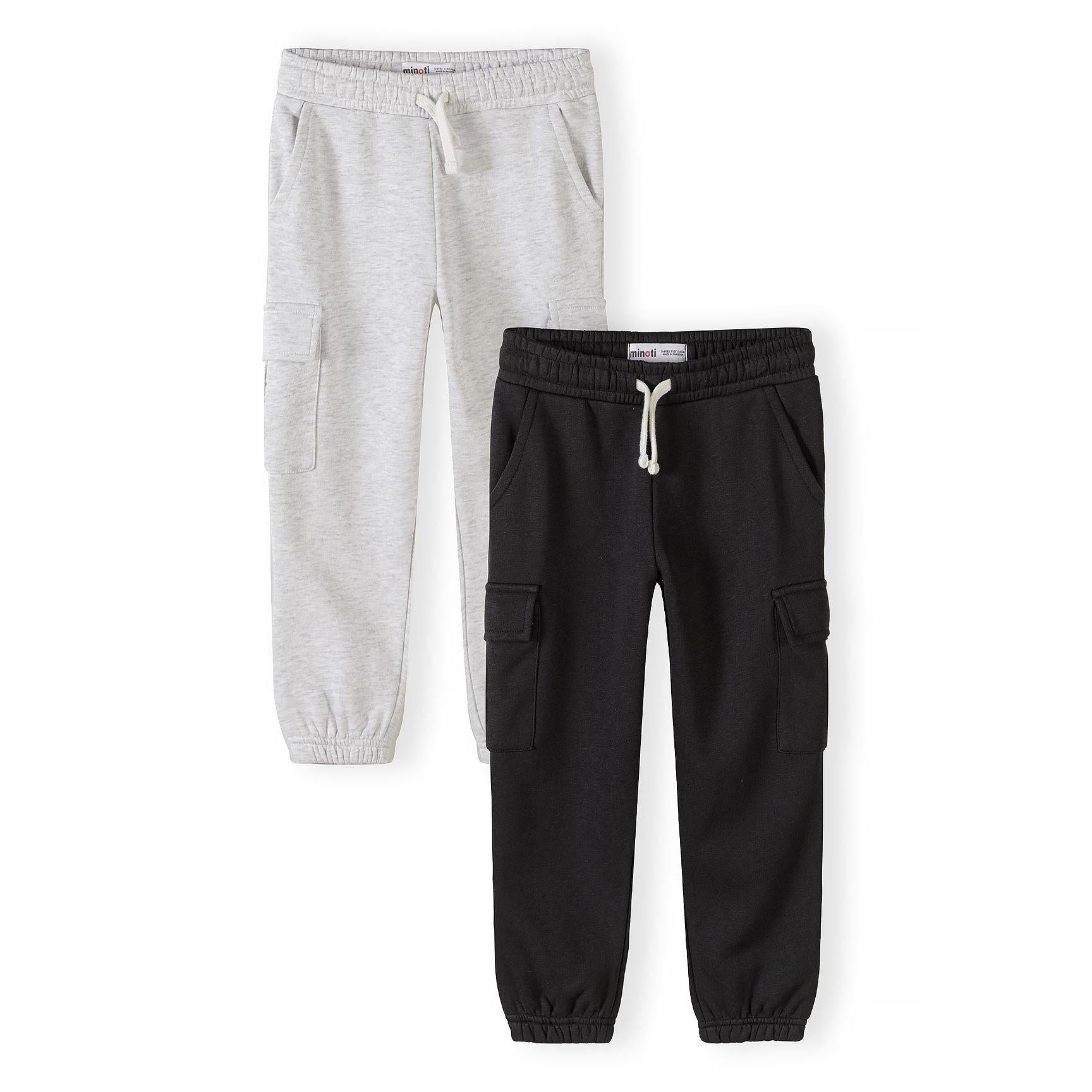 Two children's joggers laid flat - light grey marl jogger with cargo pockets and black jogger with cargo pockets, both featuring drawstring waistbands and elasticated cuffs