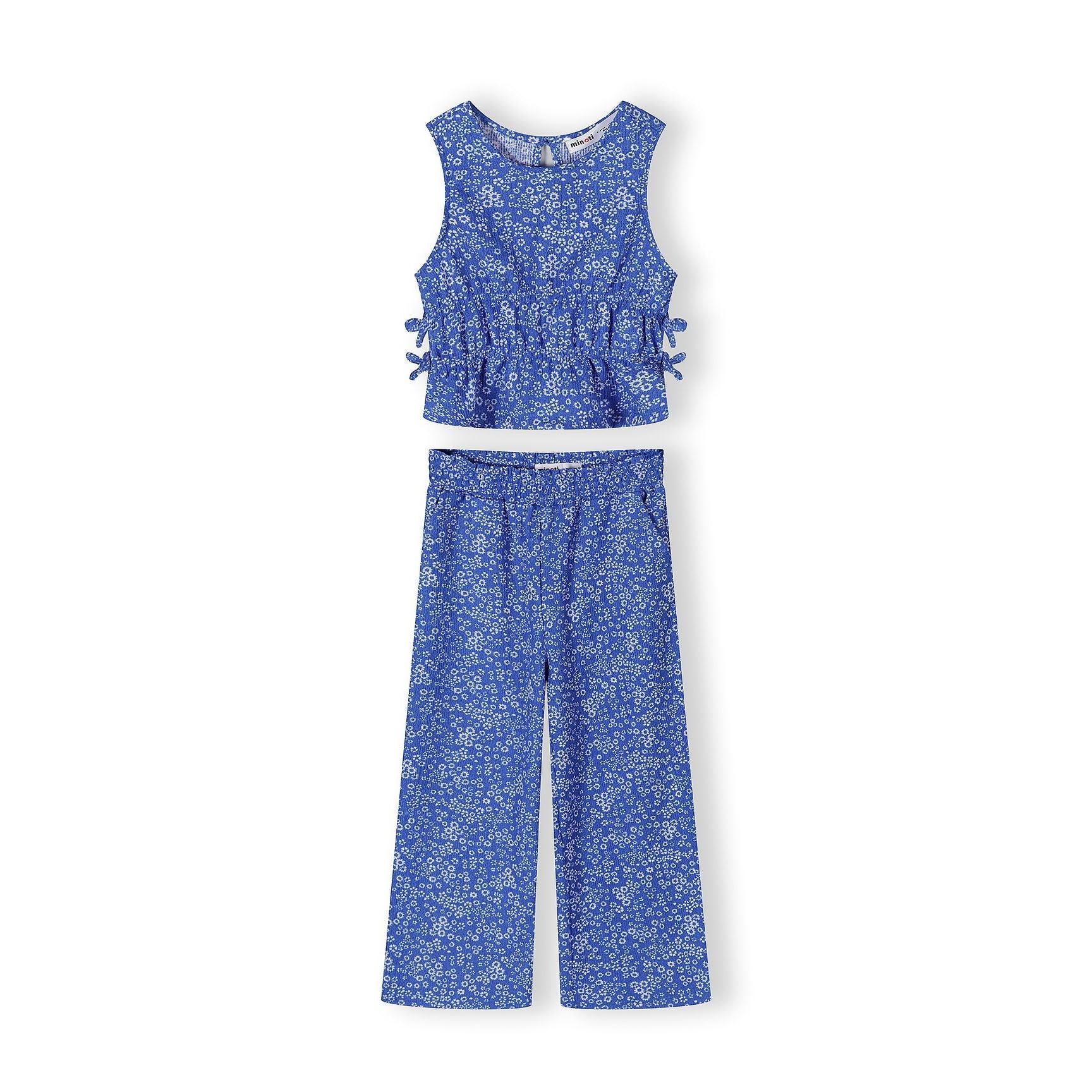 Blue floral jersey set with sleeveless top and wide-leg trousers laid flat on white background, showing coordinating small white flower print