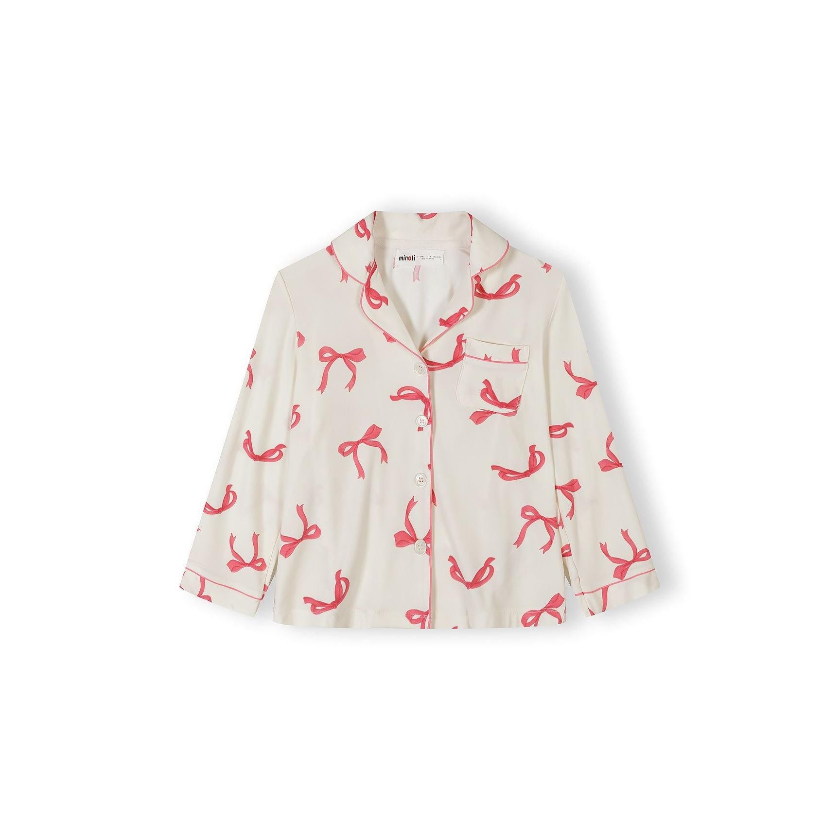 Close-up view of pyjama top showing button-up front, notched collar and pink bow print pattern on cream fabric against white background