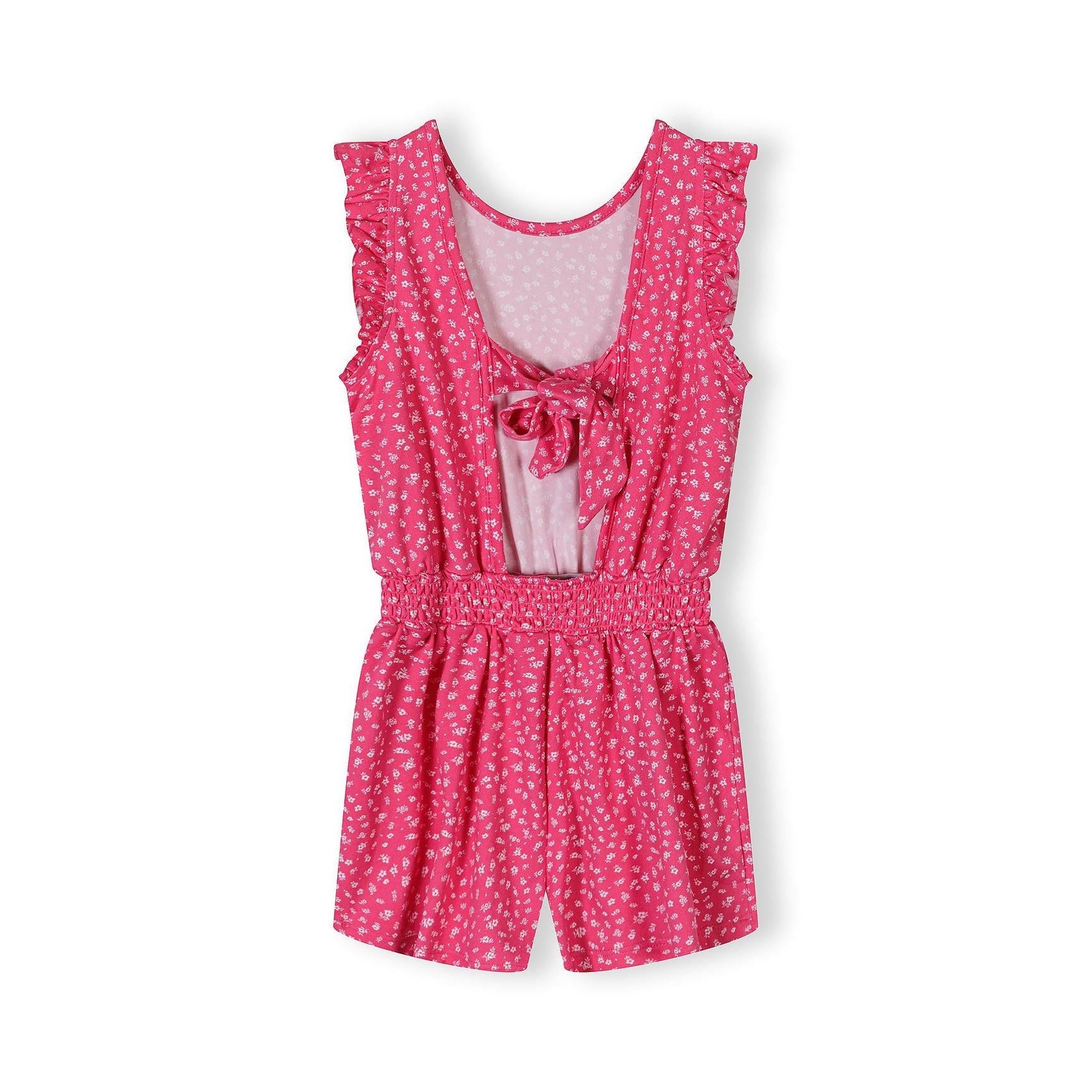 Back view of pink floral jumpsuit showing open back design with tie detail and elasticated waist