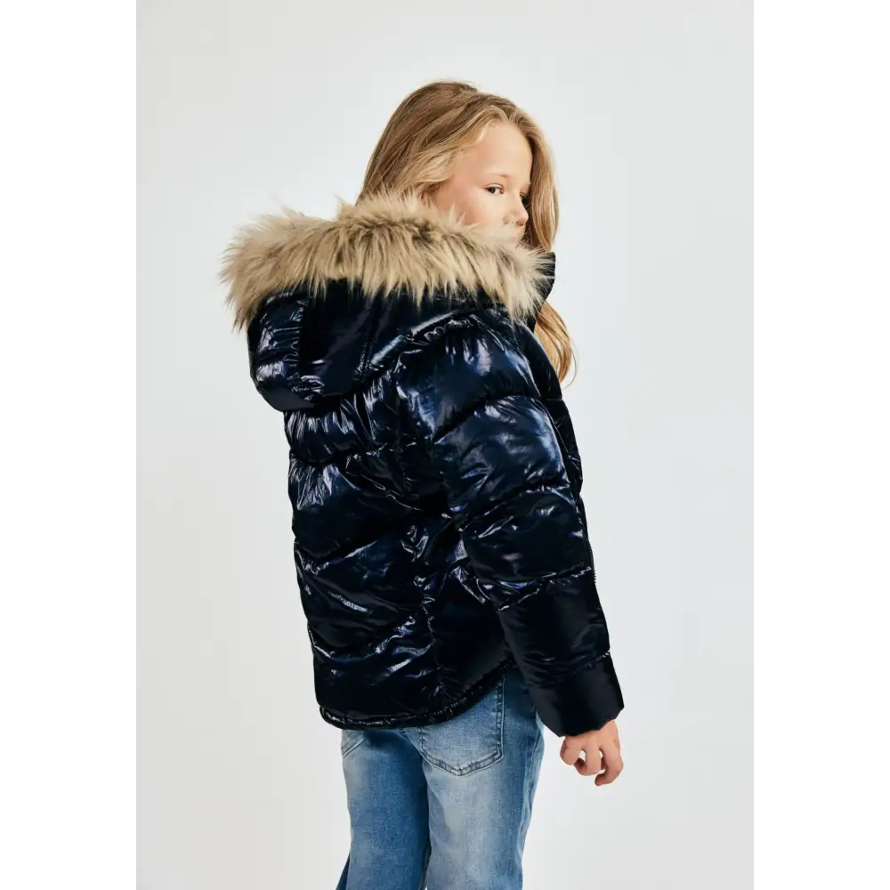 Navy metallic quilted winter jacket laid flat showing front zip closure, hood with detachable faux fur trim, and ribbed cuffs against white background