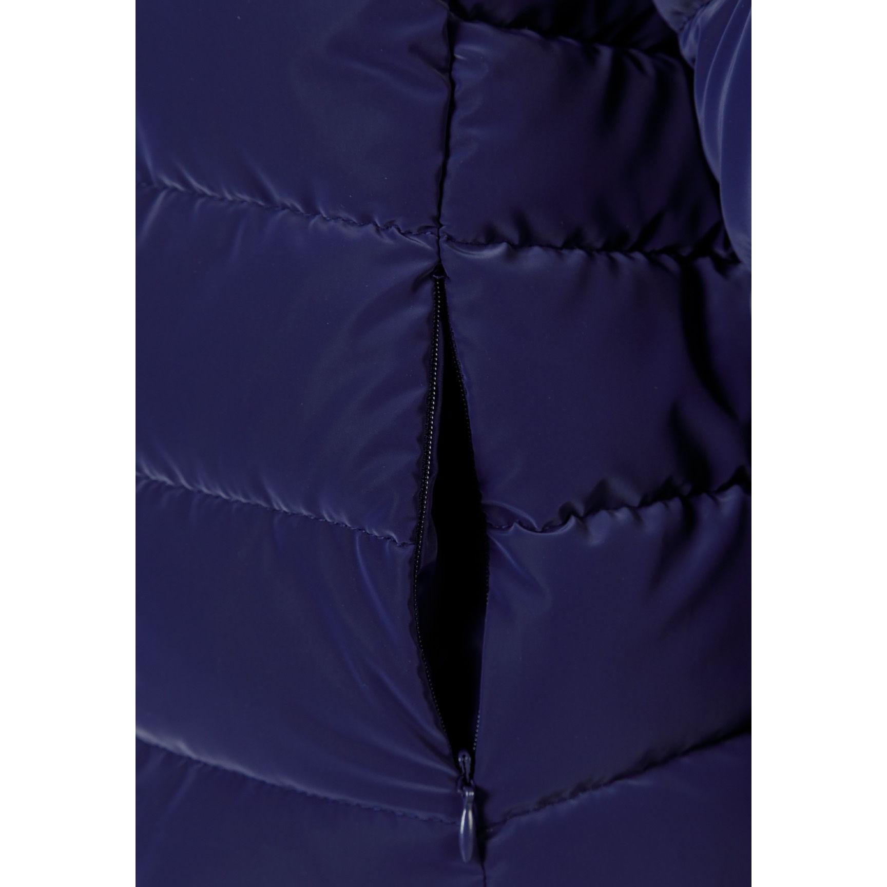 Close-up detail of navy padded jacket showing quilted texture, zip closure and soft padding construction