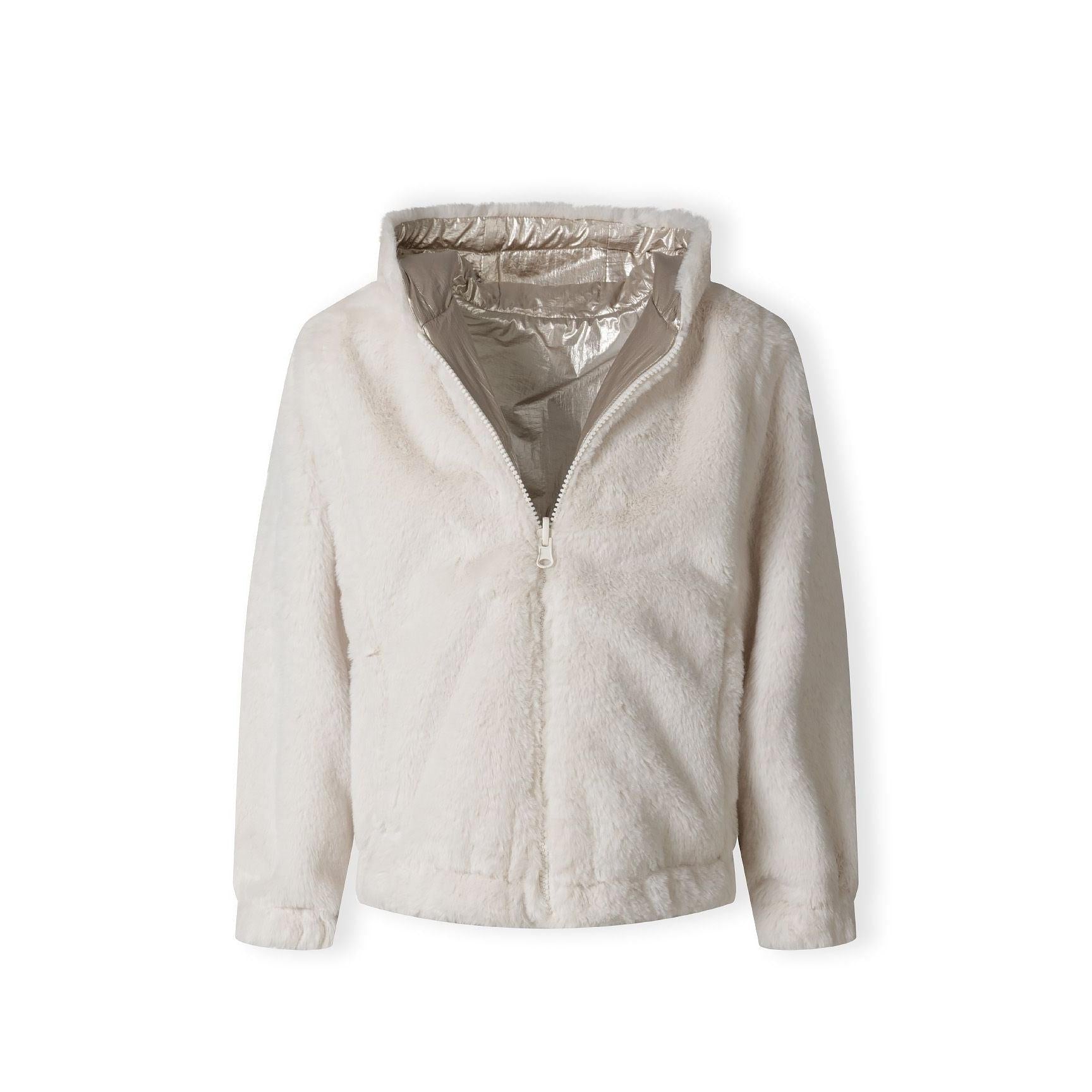 Close-up of cream teddy fur fabric texture showing soft fluffy pile and plush finish of jacket interior