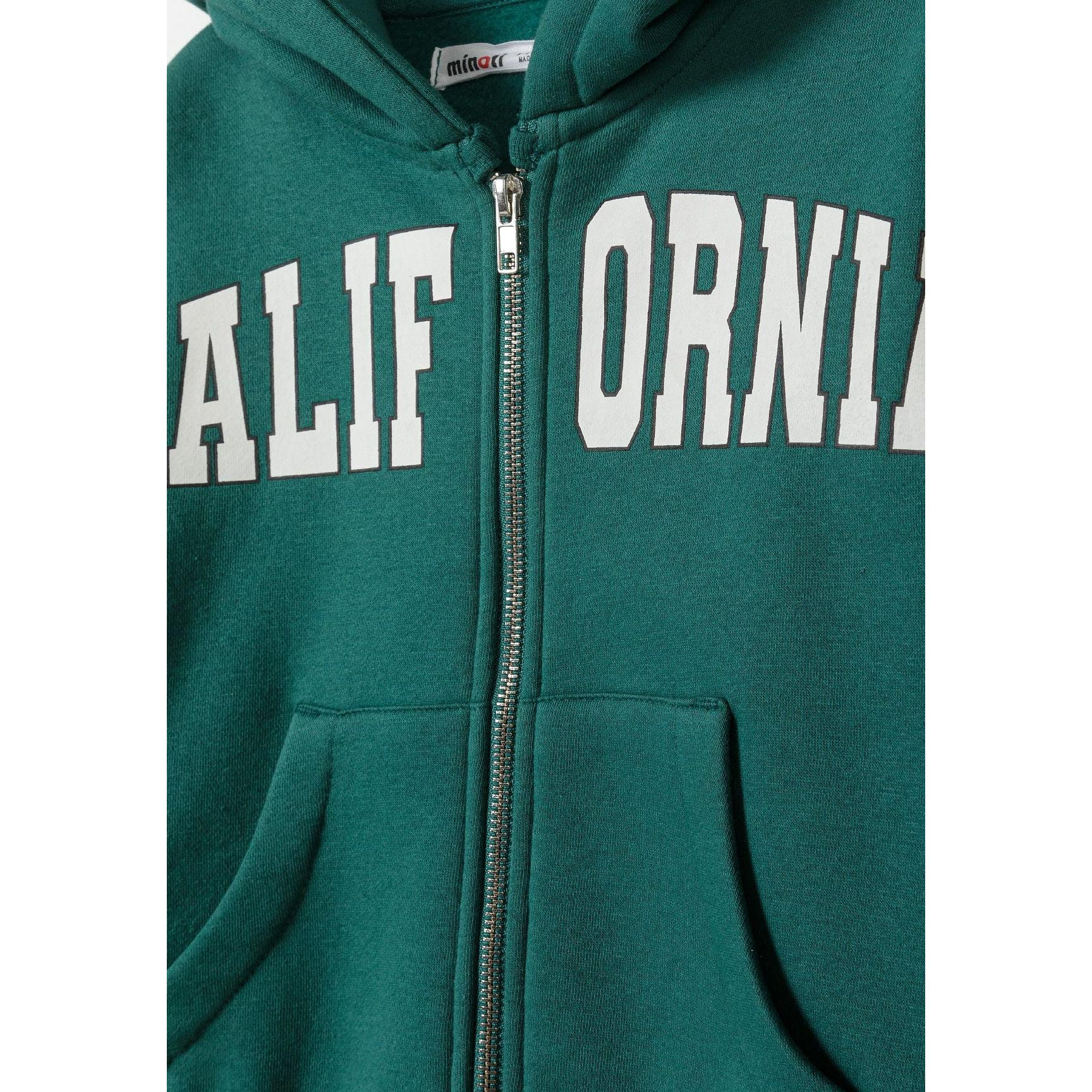 Close-up detail of green hoodie showing California lettering across chest, zip fastening, hood drawstrings and Minoti brand label