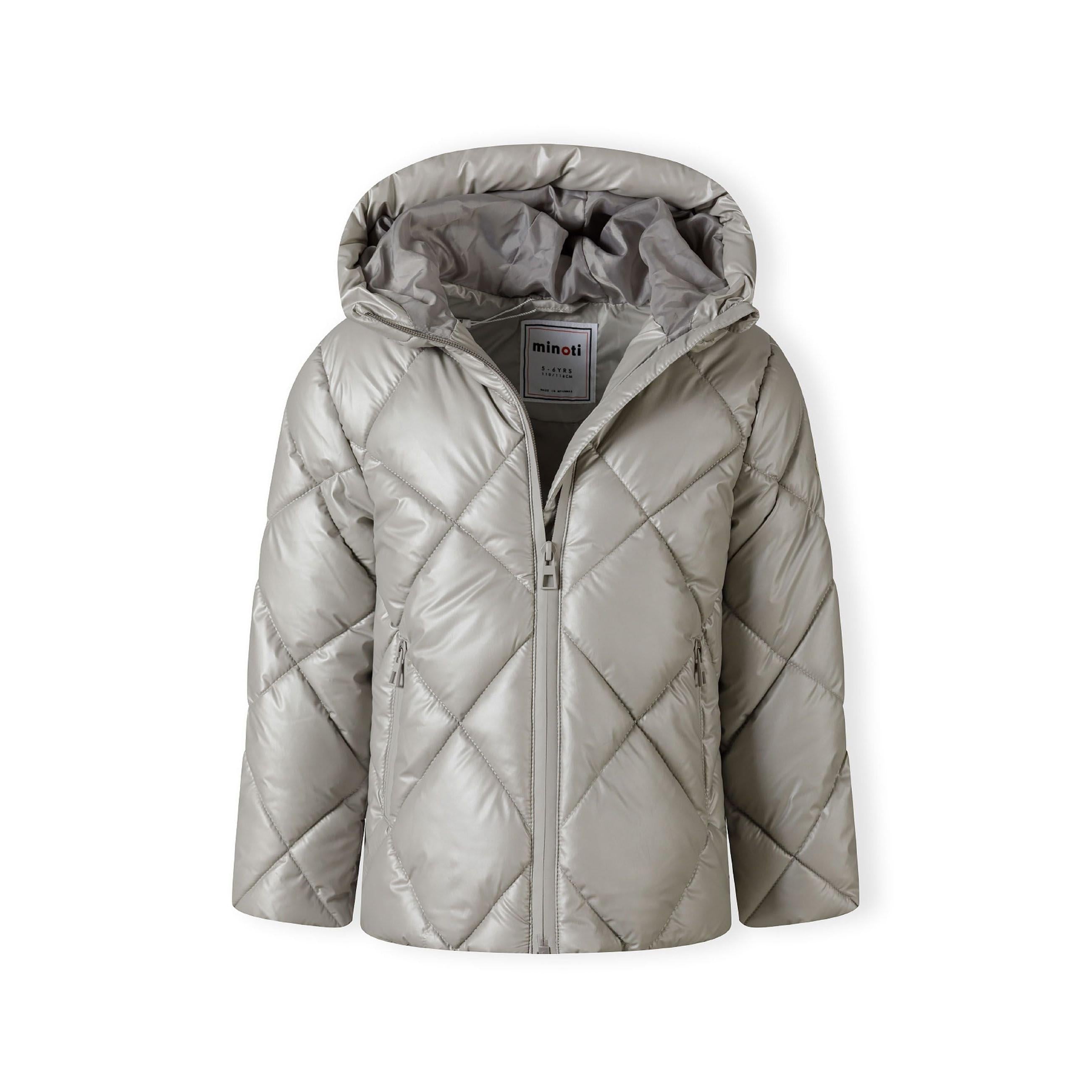 Close-up detail of silver quilted jacket showing full-zip closure and diamond quilting pattern texture