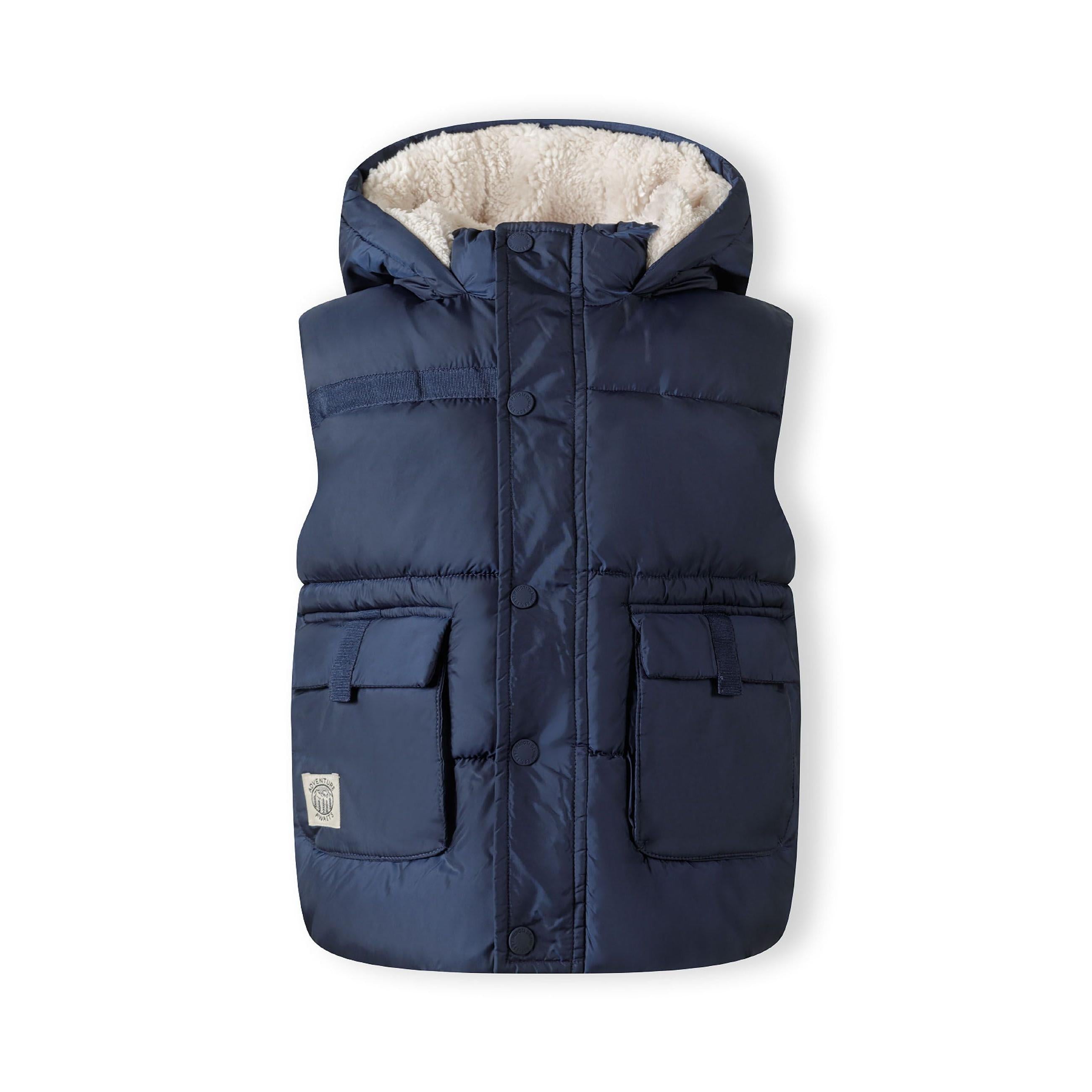 Rear view of navy quilted gilet showing hooded design and quilted panel construction on white background