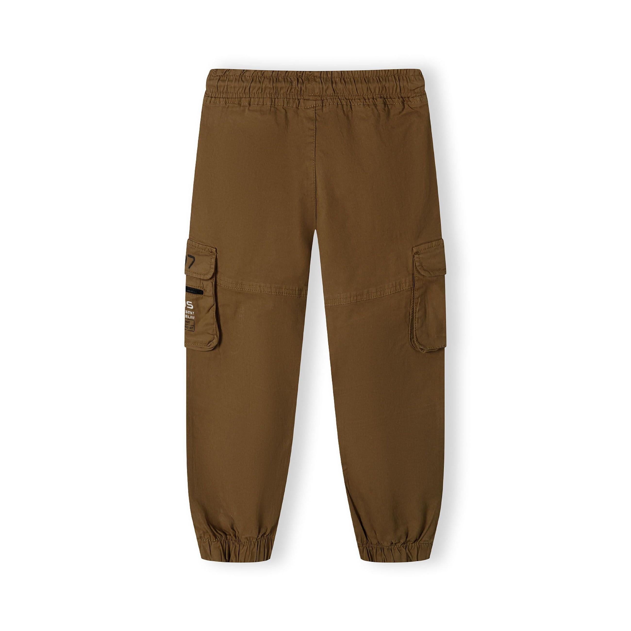 Flat lay view of beige cargo trousers showing elasticated waistband, side cargo pockets and relaxed fit styling on white background