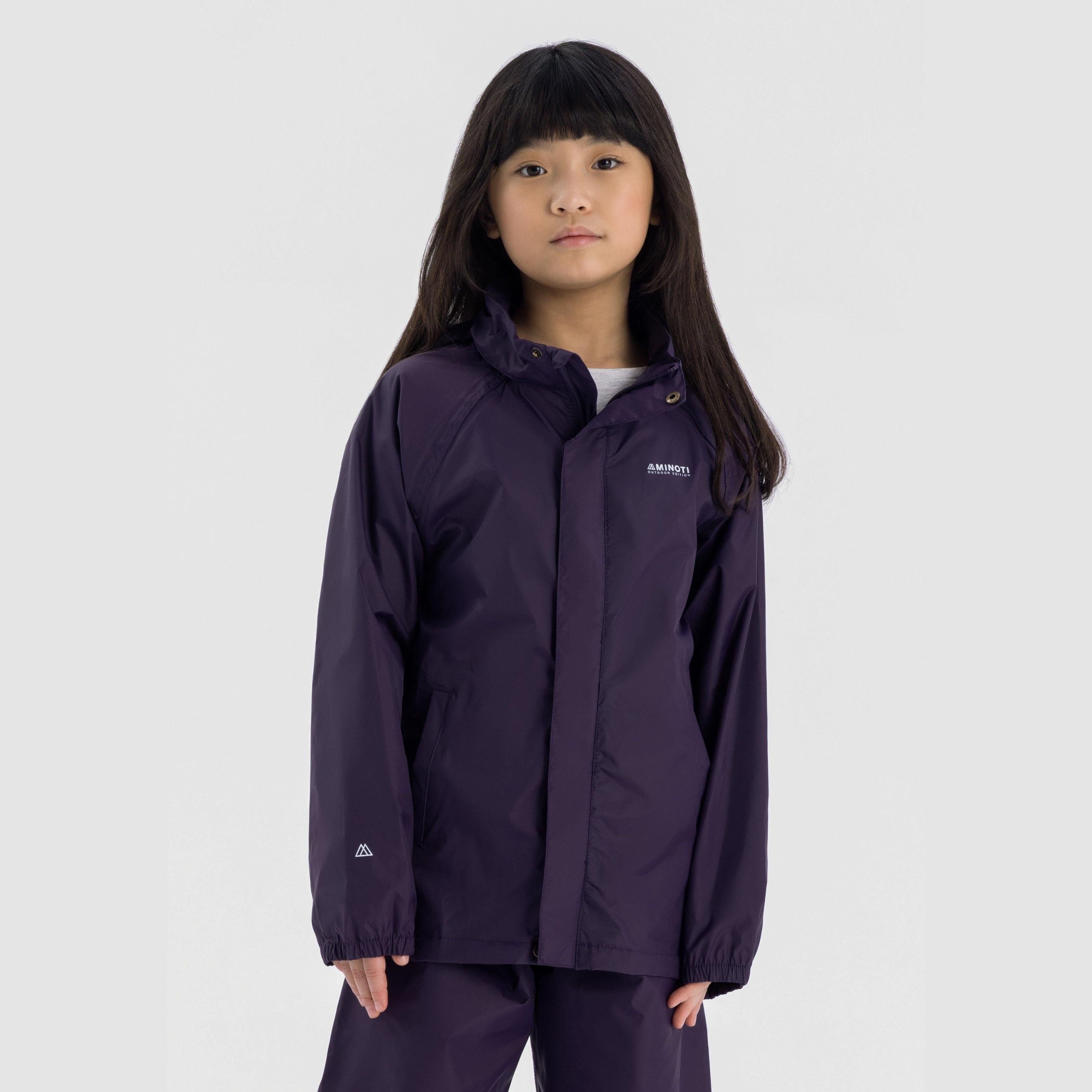 Child wearing purple packaway waterproof jacket with hood and full zip, standing against light grey background