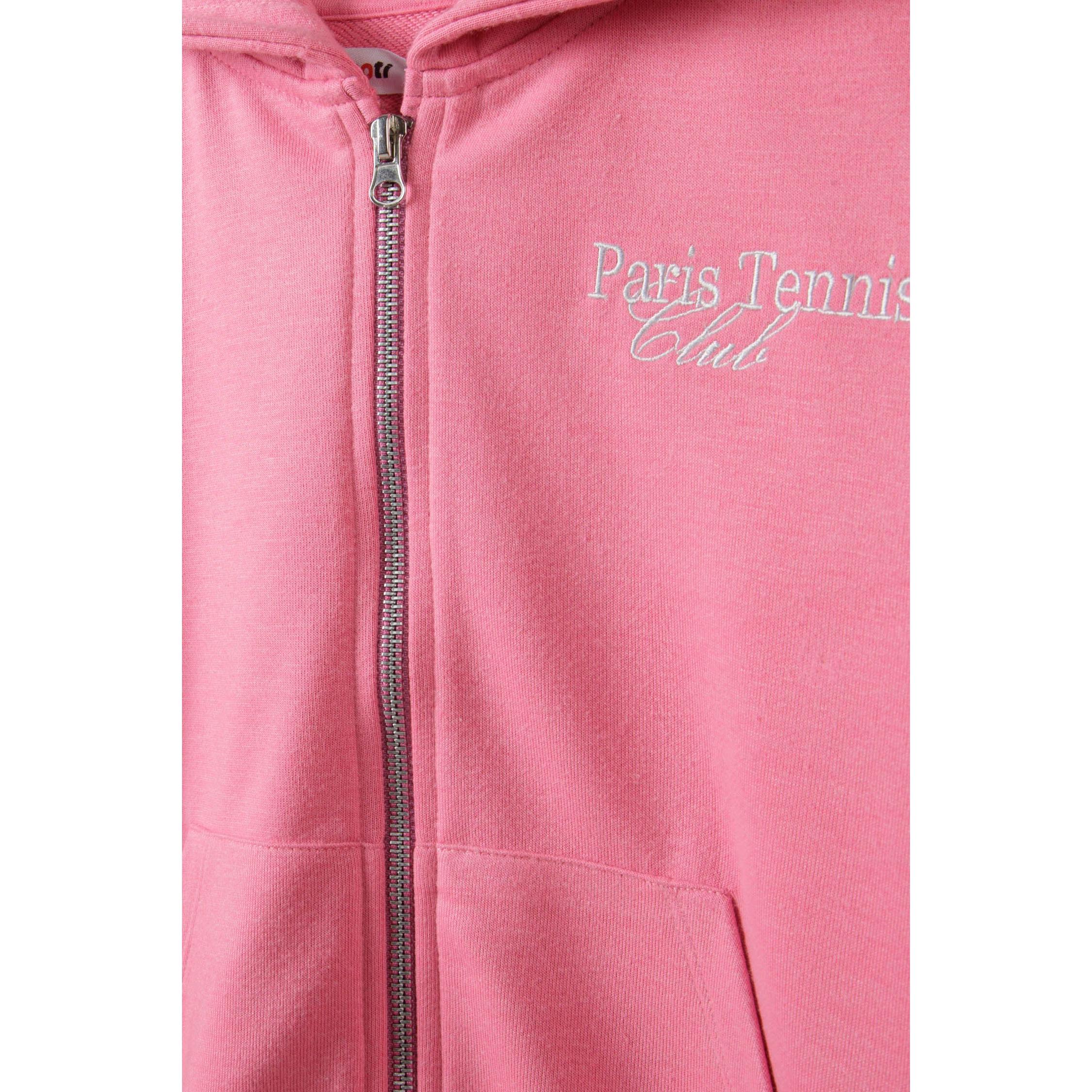 Close-up detail of pink hoodie showing embroidered Paris Tennis Club text and silver zip closure