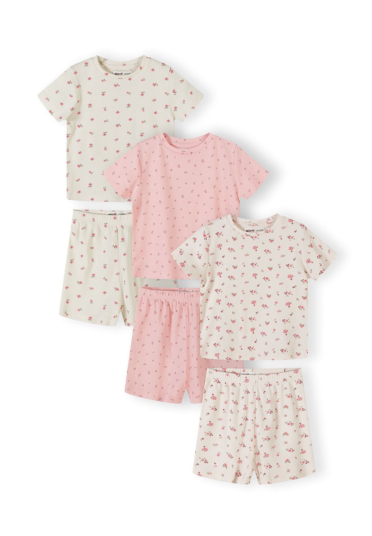 Three pyjama sets arranged on white background showing floral print tops and shorts in pink and cream colours