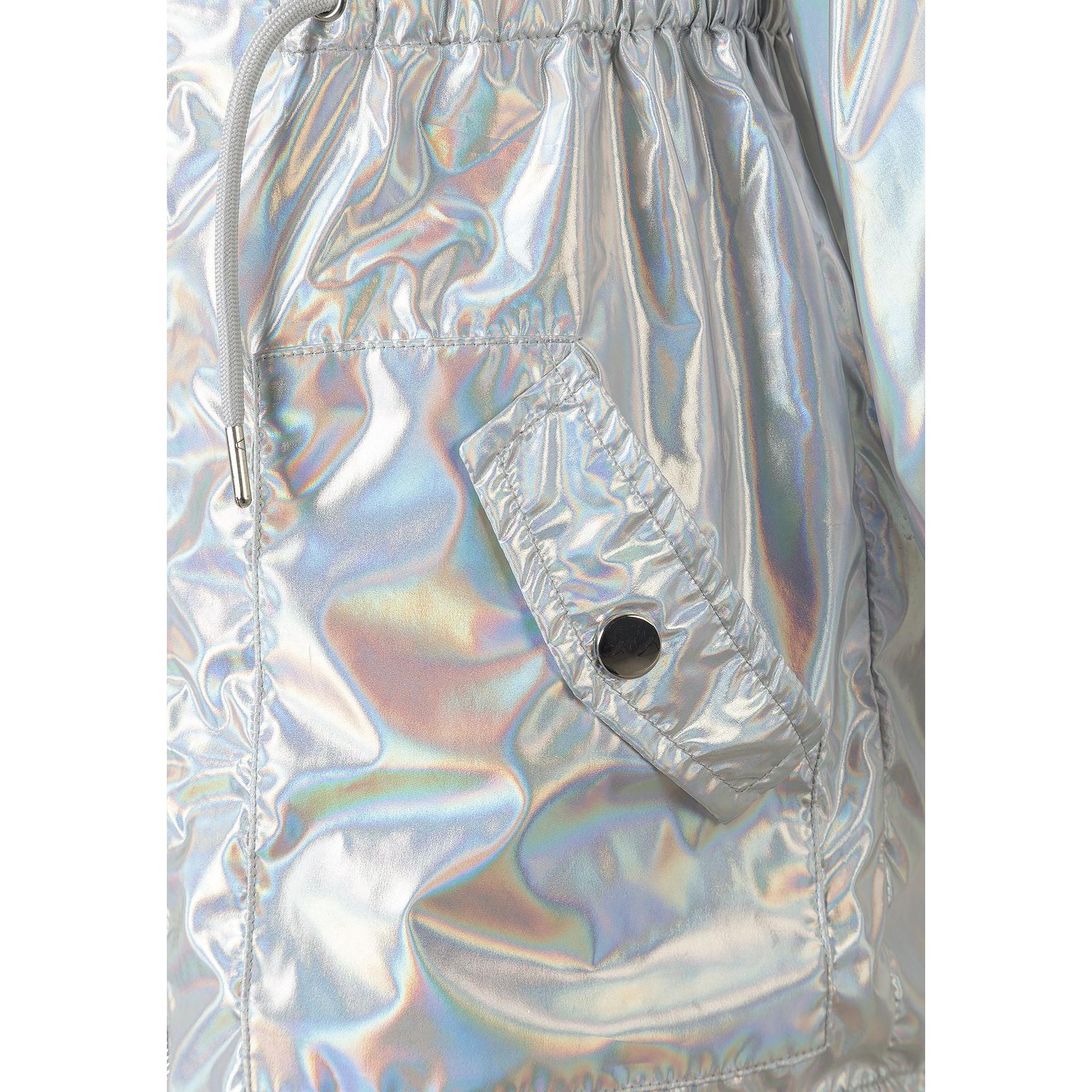 Close-up detail of silver iridescent rain jacket fabric showing the shimmery holographic effect, drawstring waist, and cargo pocket with snap closure