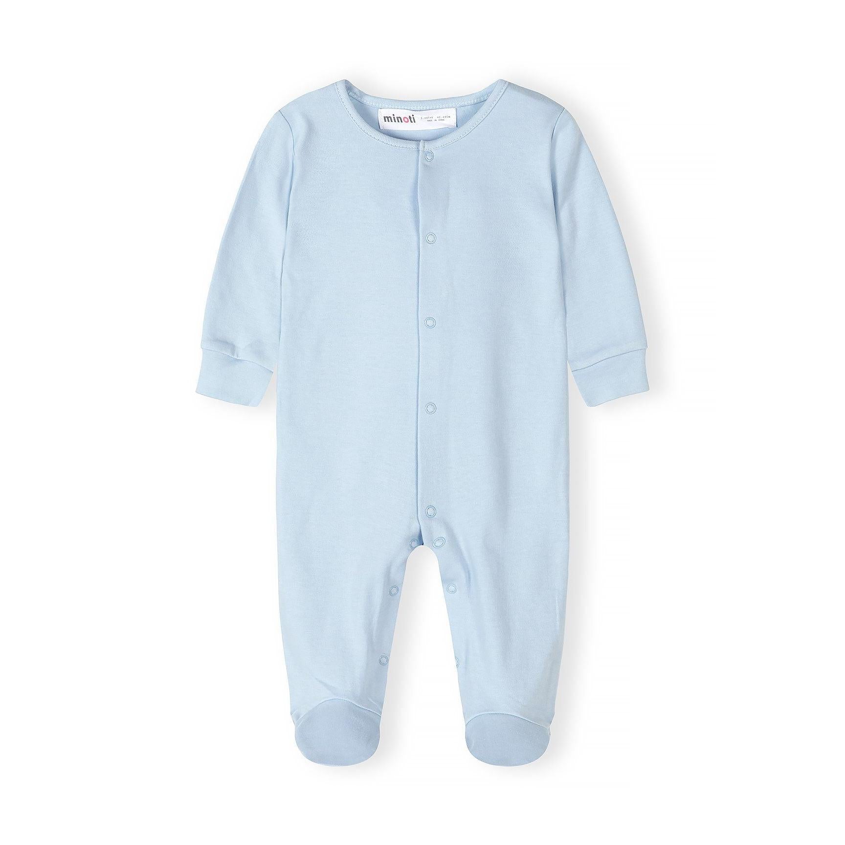 Close-up detail of mint green sleepsuit showing snap button fastenings and Minoti brand label at the neckline with soft jersey fabric texture visible