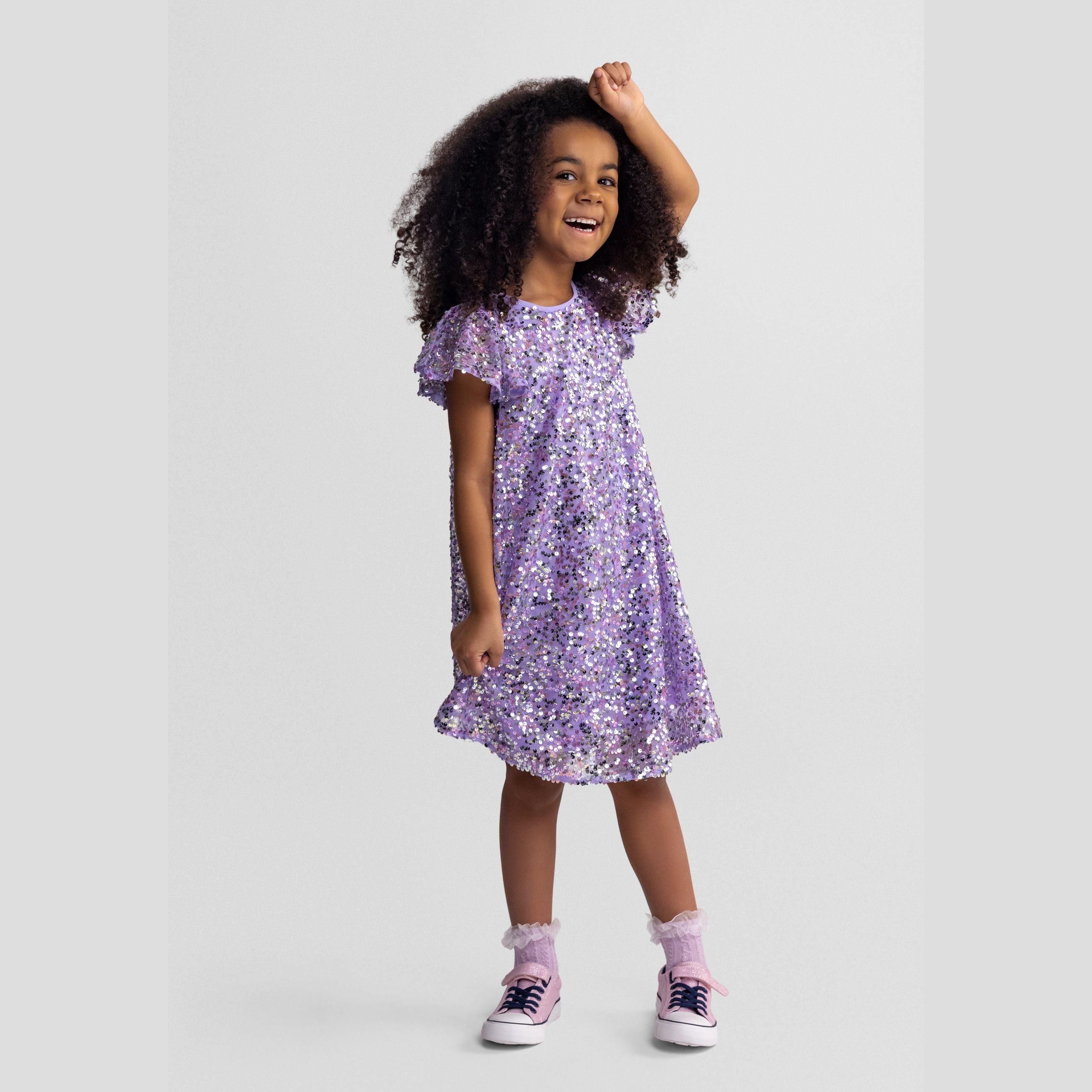 Flat lay view of purple sequin dress showing A-line shape, short sleeves, round neckline and all-over multicolour sequin embellishment on white background