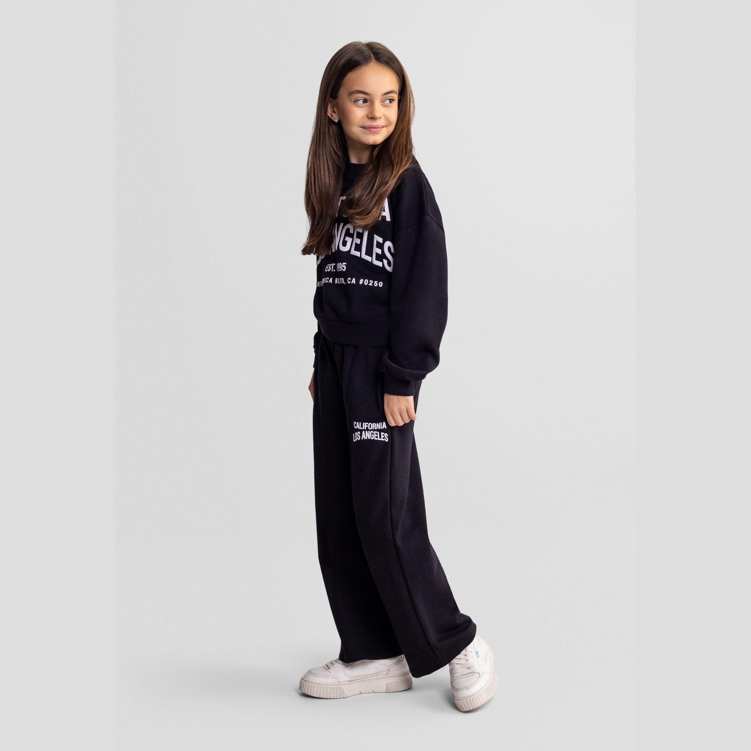 Black crew neck sweatshirt with white California Los Angeles EST 1995 Santa Monica Blvd CA 90250 text print, shown flat against white background