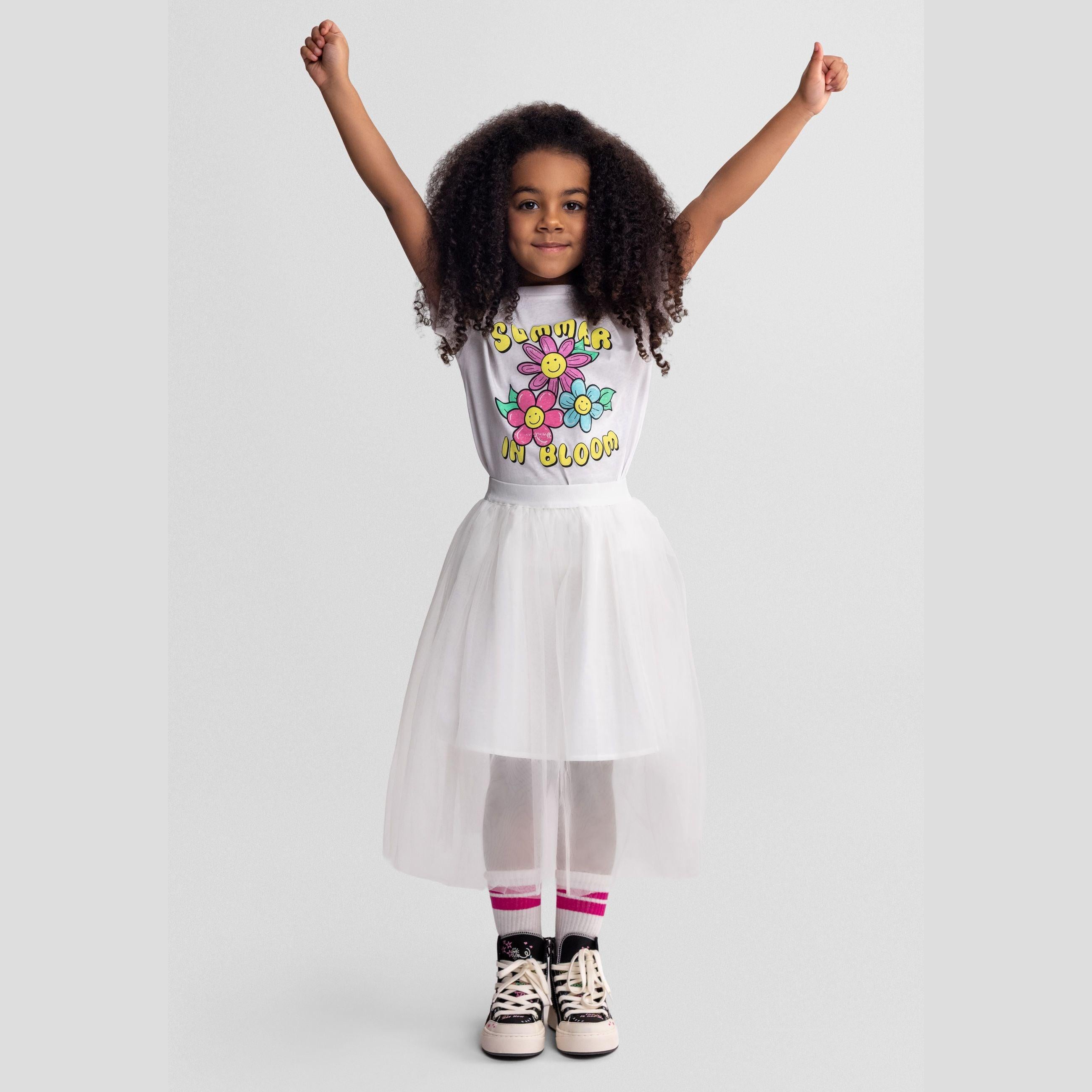 Close-up detail of off white pleated tulle fabric showing fine texture and elastic waistband construction