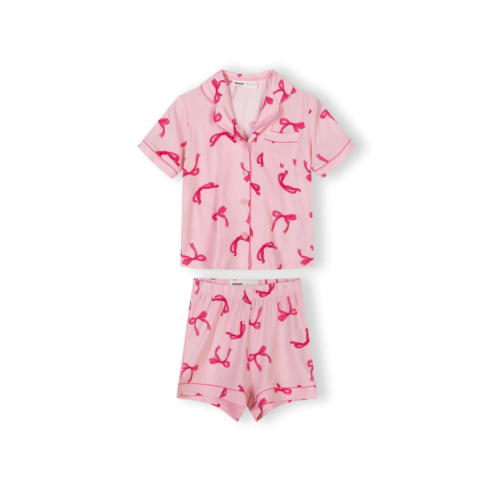 Close-up detail of pink pyjama top showing Minoti label, bow print pattern and button fastening
