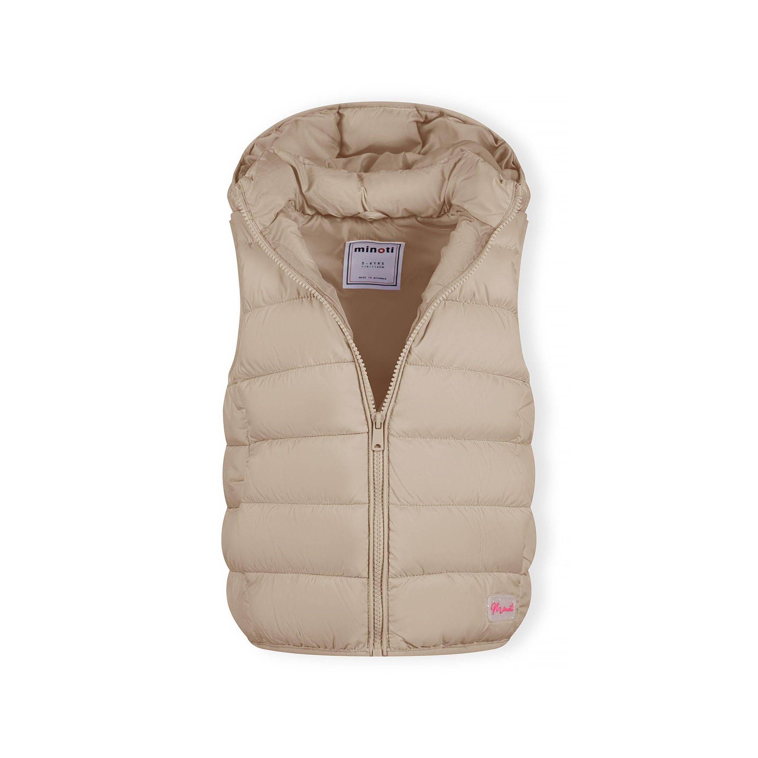 Close-up detail of beige quilted fabric showing horizontal stitching lines and Minoti brand label with pink lettering